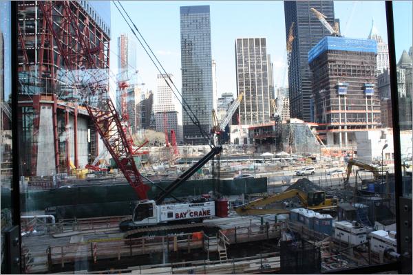 Freedom Tower base on left, memorial black at right