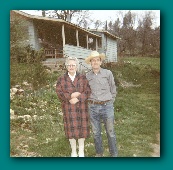Mary Ruth (Bridgham) & Charles J. Fuhs in front of their mountain home